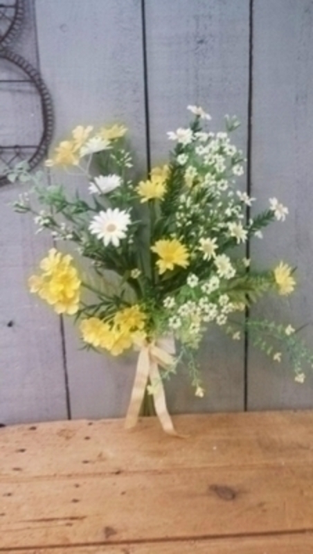 Yellow and white Buttercup and Daisy artificial pre-arranged meadow flowers by Bloomsbury. These stunning silk flowers give the impression they have just been hand picked from a meadow and would look lovely in a vase. For realistic artifical and silk flowers Bloomsbury is second to none.